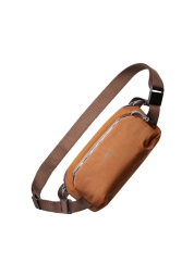 The Venture Ready Sling in bronze is an essential accessory for your next adventure, offering a secure way to carry valuables with its hidden back pocket and padded phone pocket. This compact and lightweight bag features a magnetic buckle for easy access and complete waterproofing to withstand any weather conditions. With a capacity of 2.5 litres, it's the perfect companion for those demanding field trips where hands-free convenience is a priority.